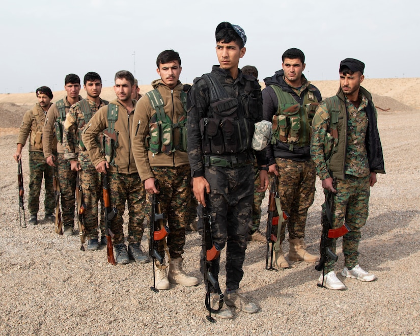 Soldiers patrol in formation.