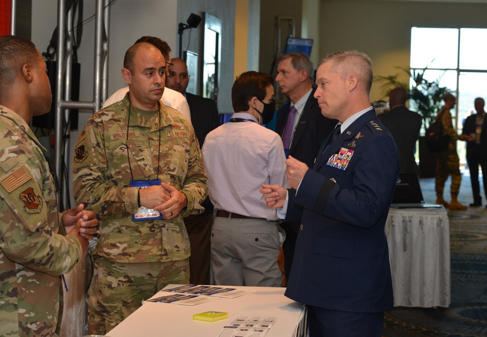 16th Air Force commander speaks to Airmen at a booth.