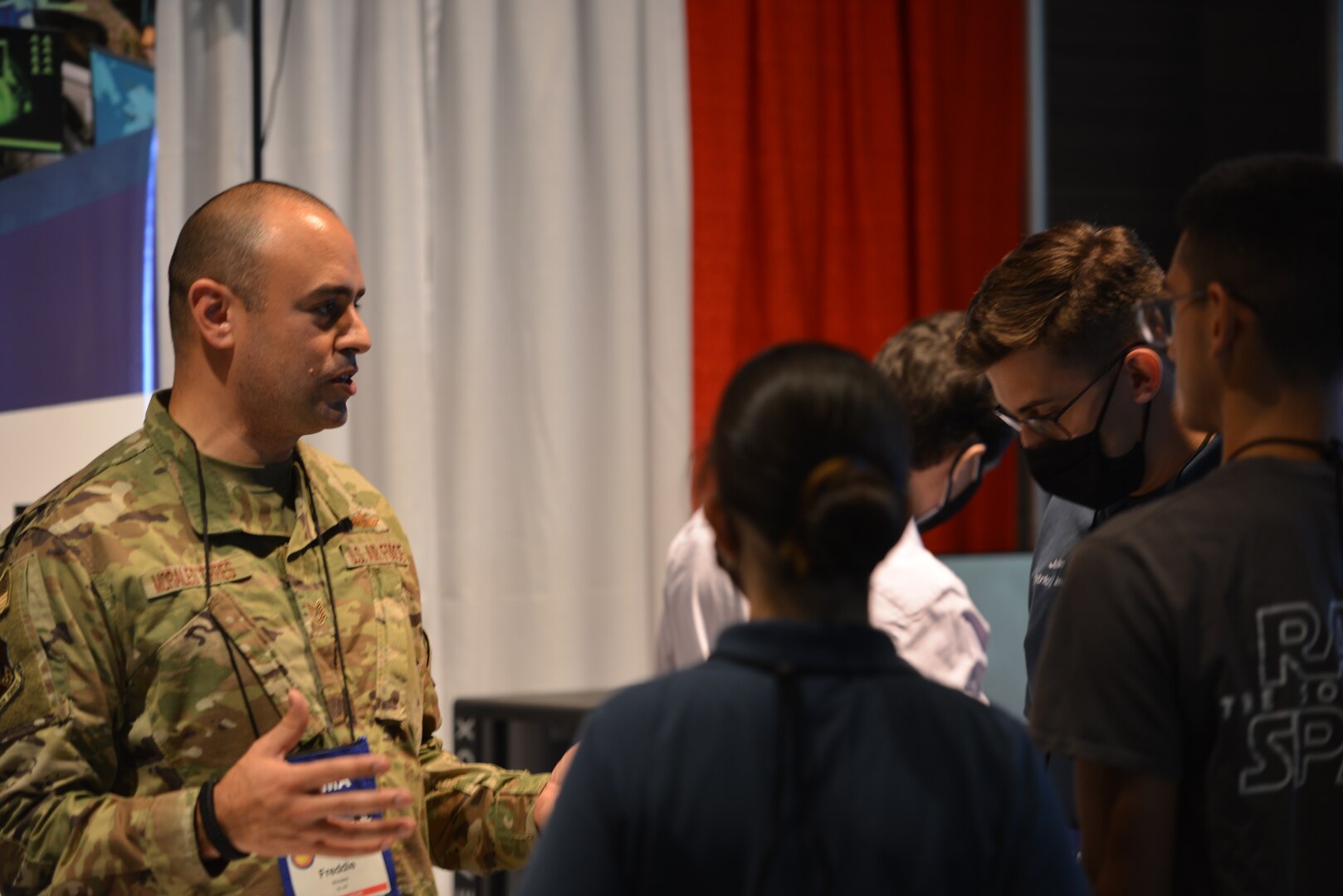 Airman speaks to youth at AFCA booth.