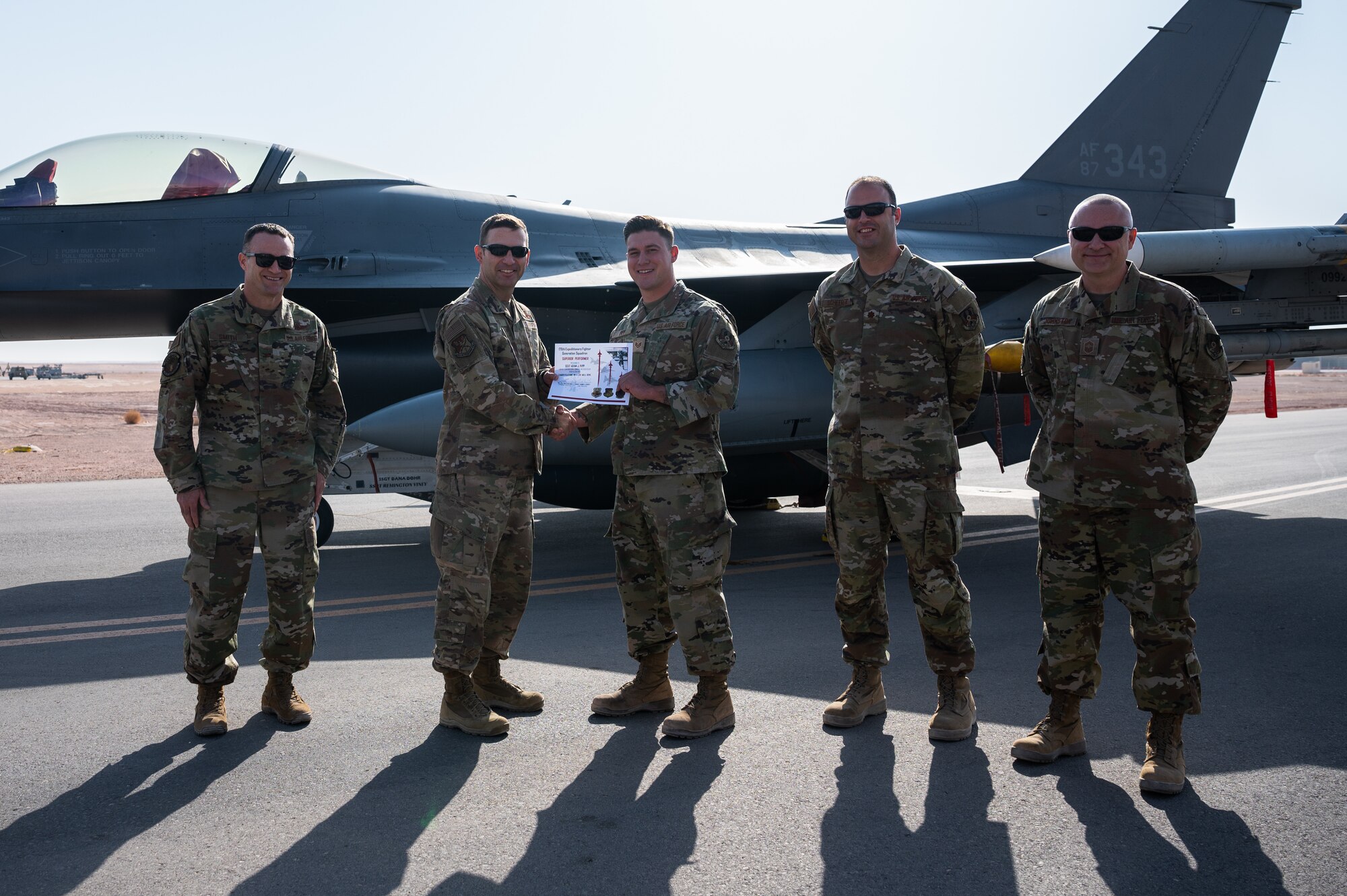 Staff Sgt. Adam Pipp, 176th Expeditionary Fighter Squadron aerospace ground equipment craftsman, receives a superior performer certificate from Brig. Gen. Robert Davis, 378th Air Expeditionary Wing commander, at Prince Sultan Air Base, Kingdom of Saudi Arabia, Nov. 23, 2021. Pipp was recognized for his superior performance in Iron Falcon 2021, a bilateral training exercise with Saudi coalition partners. (U.S. Air Force photo by Senior Airman Jacob B. Wrightsman)