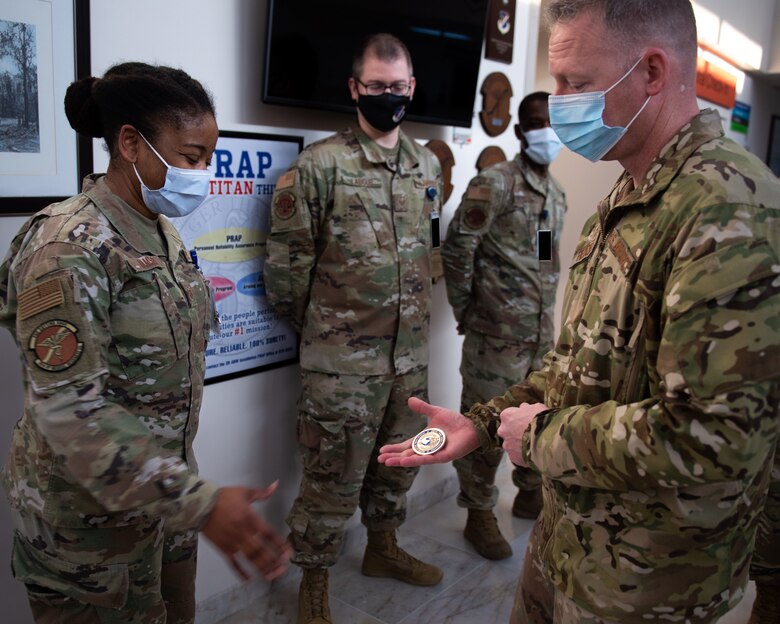 U.S. Air Force Chief Master Sgt. Benjamin Hedden, U.S. Air Forces in Europe-Air Forces Africa command chief, coins Technical Sgt. Janelle Ramsey, 39th Medical Group medical treatment facility personnel reliability assurance program monitor, during his visit to Incirlik Air Base, Turkey, Nov. 23, 2021. Hedden traveled to Incirlik AB to meet with Airmen assigned to the 39th Air Base Wing, learn about their capabilities and gain insight into the wing’s mission in defending NATO’s southern flank. (U.S. Air Force photo by Senior Airman Matthew Angulo)