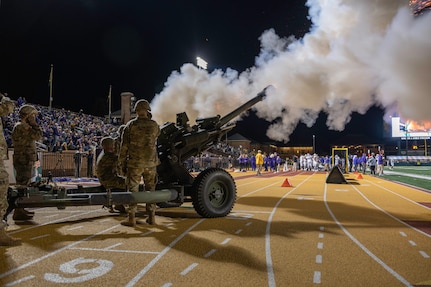 First Lt. Todd W. Weaver is inducted into the Army ROTC Hall of Fame during a military appreciation football game Nov. 13, 2021, at the College of William and Mary. Weaver started his military career in the Virginia National Guard before transitioning to active duty and was killed in action during a night ambush operation in Afghanistan Sept. 9, 2010. Brig. Gen. James W. Ring, Director of the Joint Staff for the Virginia National Guard, presided over the induction ceremony and recognized Weaver’s family on the field. Virginia National Guard cannon crews assigned to the Hanover-based Alpha Battery, 1st Battalion, 111th Field Artillery Regiment, 116th Infantry Brigade Combat Team and UH-60 Black Hawk helicopters assigned to the Sandston-based 2nd Battalion, 224th Aviation Regiment, 29th Infantry Division supported the event with cannon fire and a flyover. (U.S. Army National Guard Photo by Staff Sgt. Lisa M. Sadler)