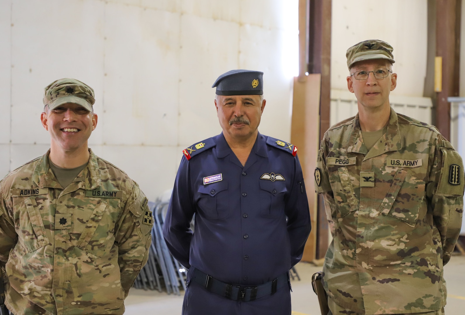 Iraqi Air Force Maj. Gen. Abbas Fadel Damer, Al Asad Air Base commander, stands alongside Lt. Col. Nathan Adkins, 329th Regional Support Group commander, and Col. Todd Pegg, 329th RSG outgoing commander, during a transfer of authority ceremony Nov. 23, 2021, at Al Asad Air Base, Iraq. AAAB, an Iraqi-run installation, conducts operations in support of Combined Joint Task Force-Operation Inherent Resolve, a multi-national coalition charged with advising, assisting and enabling Iraqi partners to maintain the enduring defeat of Daesh. Adkins will oversee support and coordinate efforts between core base functions to enable operations at AAAB, while the unit headquarters will move to Camp Arifjan, Kuwait, in efforts to further the advise, assist, and enable mission of CJTF-OIR. (U.S. Army photo by Maj. Alexa Carlo-Hickman)