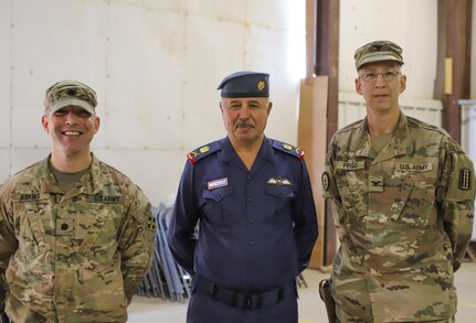 Iraqi Air Force Maj. Gen. Abbas Fadel Damer, Al Asad Air Base commander, stands alongside Lt. Col. Nathan Adkins, 329th Regional Support Group commander, and Col. Todd Pegg, 329th RSG outgoing commander, during a transfer of authority ceremony Nov. 23, 2021, at Al Asad Air Base, Iraq. AAAB, an Iraqi-run installation, conducts operations in support of Combined Joint Task Force-Operation Inherent Resolve, a multi-national coalition charged with advising, assisting and enabling Iraqi partners to maintain the enduring defeat of Daesh. Adkins will oversee support and coordinate efforts between core base functions to enable operations at AAAB, while the unit headquarters will move to Camp Arifjan, Kuwait, in efforts to further the advise, assist, and enable mission of CJTF-OIR. (U.S. Army photo by Maj. Alexa Carlo-Hickman)
