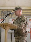 Col. Todd Pegg, 329th Regional Support Group outgoing commander, is presented with a gift at a transfer of authority ceremony Nov. 23, 2021, at Al Asad Air Base, Iraq. the 329th RSG headquarters element repositioned to Camp Arifjan, Kuwait, as part of Combined Joint Task Force’s advise, assist, and enable phase, while the rest of the 329th RSG will remain at AAAB to conduct base operations support. (U.S. Army photo by Maj. Alexa Carlo-Hickman)