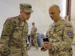 Lt. Col. Nathan Adkins, 329th Regional Support Group commander, speaks at a transfer of authority ceremony Nov. 23, 2021, at Al Asad Air Base, Iraq. AAAB, an Iraqi-run installation, conducts operations in support of Combined Joint Task Force-Operation Inherent Resolve, a multi-national coalition charged with advising, assisting and enabling Iraqi partners to maintain the enduring defeat of Daesh.(U.S. Army photo by Maj. Alexa Carlo-Hickman)