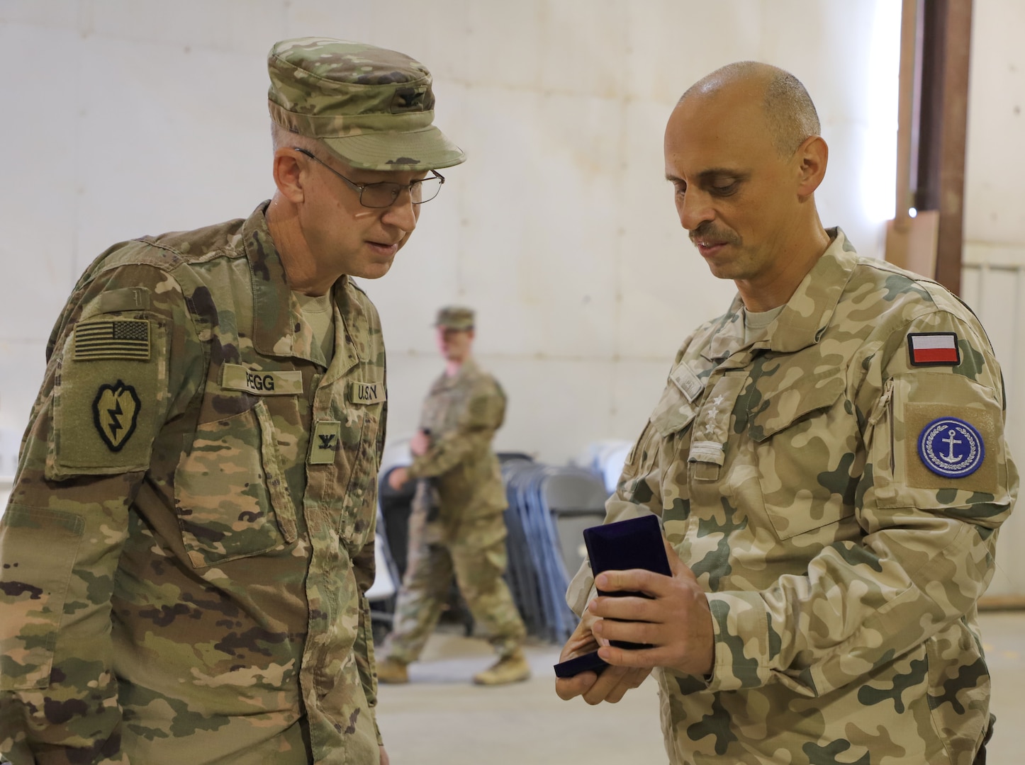 Lt. Col. Nathan Adkins, 329th Regional Support Group commander, speaks at a transfer of authority ceremony Nov. 23, 2021, at Al Asad Air Base, Iraq. AAAB, an Iraqi-run installation, conducts operations in support of Combined Joint Task Force-Operation Inherent Resolve, a multi-national coalition charged with advising, assisting and enabling Iraqi partners to maintain the enduring defeat of Daesh.(U.S. Army photo by Maj. Alexa Carlo-Hickman)