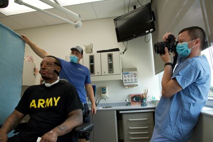 Doctor photographs patient's facial mask