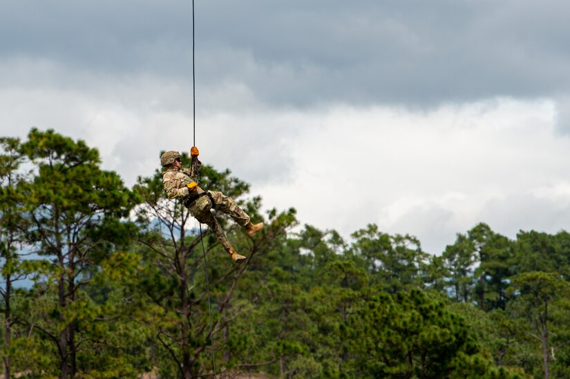 A Soldier from the Security Force Assistance Brigade (SFAB) Team 1231, Joint Task Force Bravo, rappels out of a CH-47 Chinook assigned to the 1st Battalion, 228th Aviation Regiment during an exercise near Soto Cano Air Base, Honduras, Nov. 24, 2021.