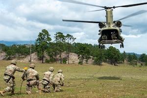U.S. Army Soldiers from the Security Force Assistance Brigade (SFAB) Team 1231, Joint Task Force Bravo, prepare a rope for rappelling training with a CH-47 Chinook assigned to the 1st Battalion, 228th Aviation Regiment, near Soto Cano Air Base, Honduras, Nov. 24, 2021.
