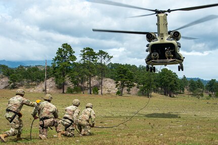 U.S. Army Soldiers from the Security Force Assistance Brigade (SFAB) Team 1231, Joint Task Force Bravo, prepare a rope for rappelling training with a CH-47 Chinook assigned to the 1st Battalion, 228th Aviation Regiment, near Soto Cano Air Base, Honduras, Nov. 24, 2021.