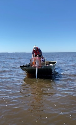 Kasea Price, research technician at The University of Southern Mississippi, deploys an acoustic telemetry receiver to monitor for fish movements around open bottom habitats near Bay of St. Louis. (Photo credit: Alfonso Cohuo, The University of Southern Mississippi)