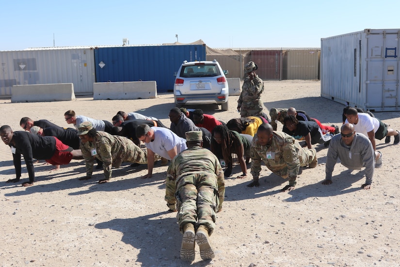 Sgt. 1st Class Keith Frazier places students in the front leaning rest during an Equal Opportunity Leader course at Camp Buehring, Kuwait. The students were participating in the StarPower game in which they experience what it is like to be discriminated against. (Maj. Jason Sweeney)