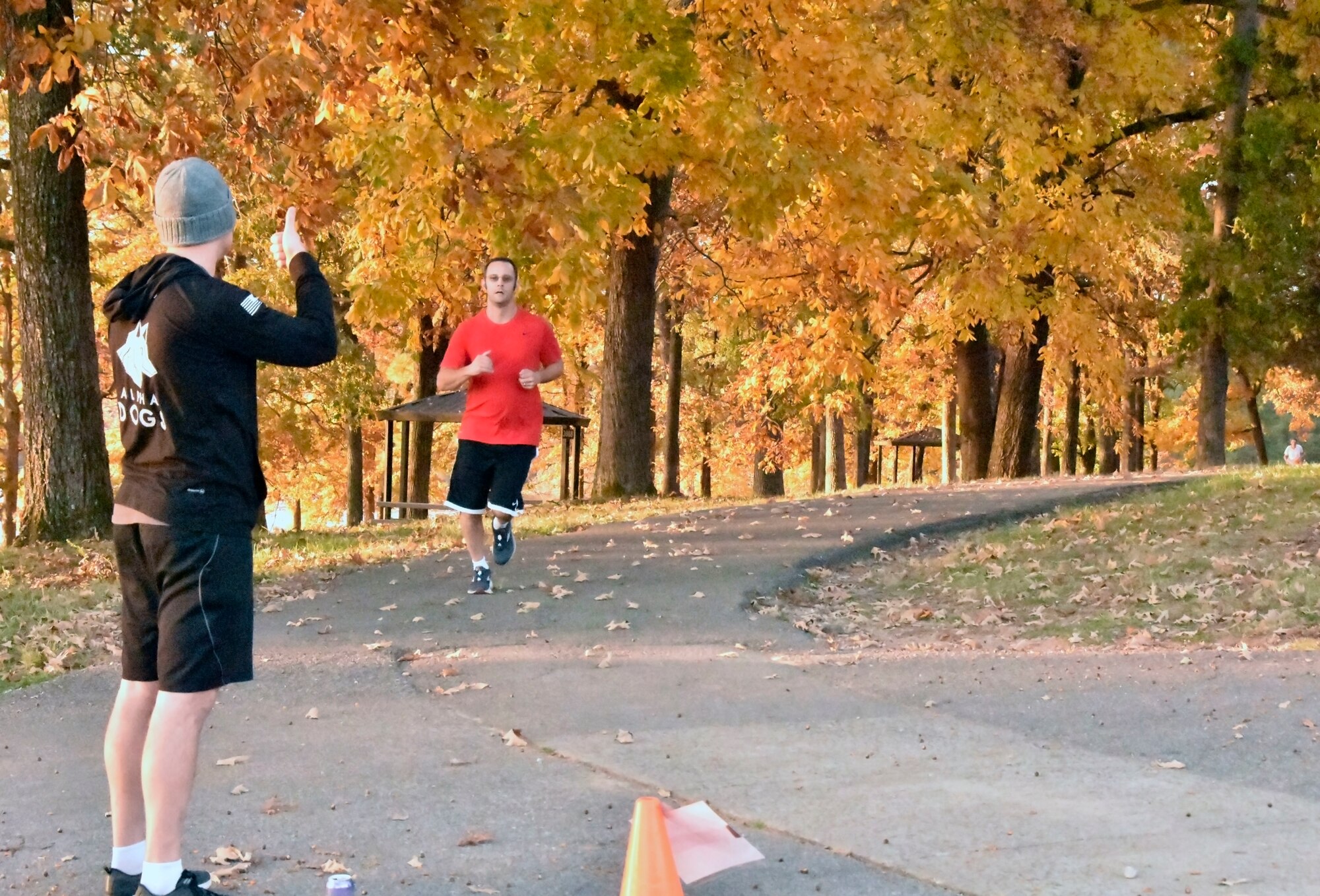 Harry Cooper, right, receives a thumbs up from 2nd Lt. Mason Lucas as he nears the end of a lap during the 36th annual Arnold Engineering Development Complex Turkey Trot, Nov. 10, 2021, at the Arnold Lakeside Complex on Arnold Air Force Base, Tenn. This year’s race was again hosted by the Company Grade Officers’ Council at Arnold. Lucas is among those who helped organize the event. (U.S. Air Force photo by Bradley Hicks)