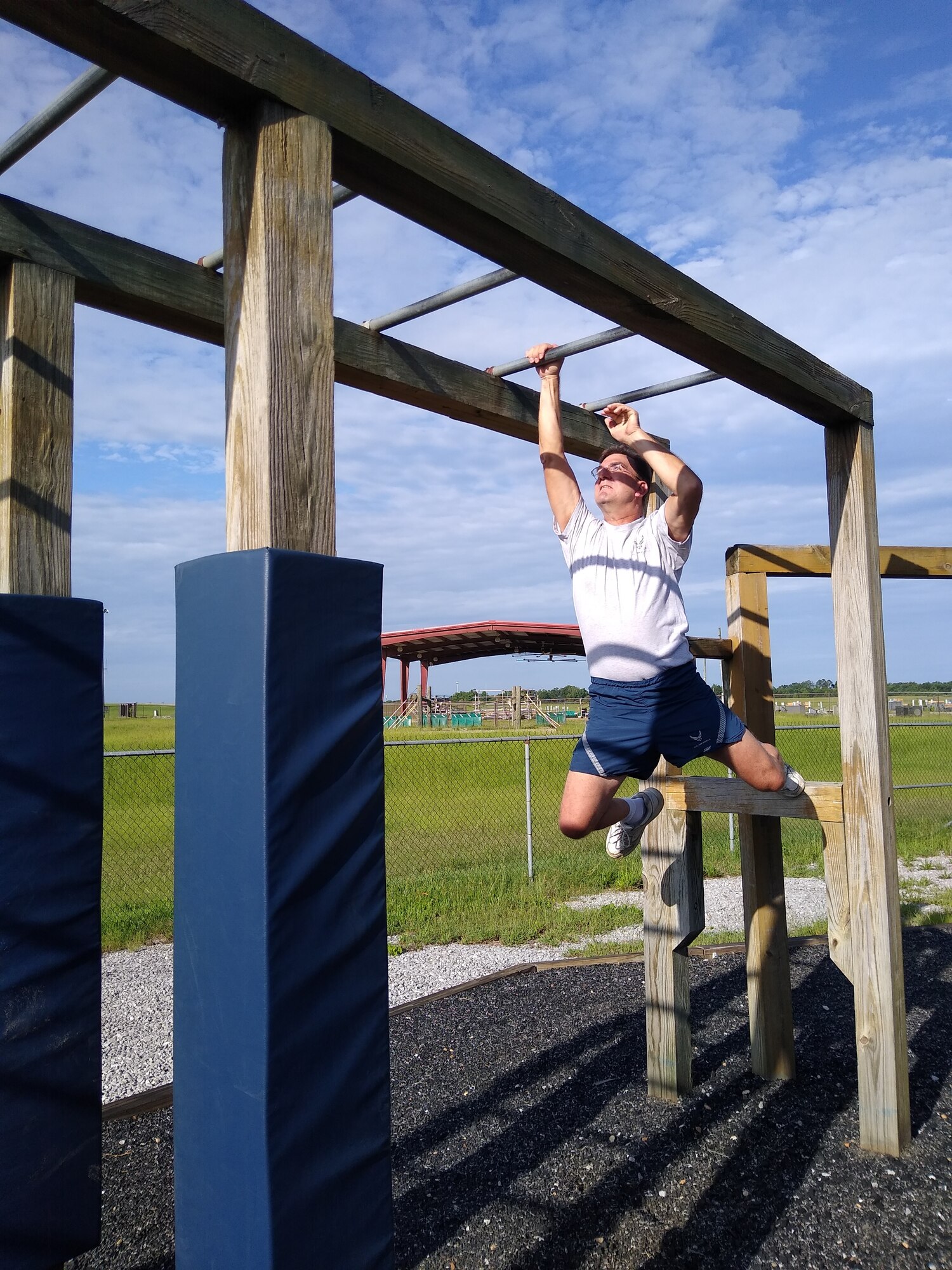 Senior Master Sgt. John Moon, 908th Airlift Wing, 25th Aerial Port Squadron, swings across an obstacle at the U.S. Air Force Officer Training School’s “Project X” on Maxwell Air Force Base, Ala., July 10. The event was a team-building and morale-boosting exercise which challenged participants’ problem-solving skills as well as physical fitness. (U.S. Air Force photo by Chief Master Sgt. Tracey Piel)