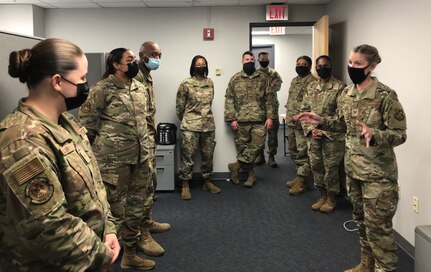 U.S. Air Force Col. Cat Logan, Joint Base Anacostia-Bolling and 11th Wing commander, far right, speaks to staff of the 11th Comptroller Squadron during a break as they work to complete the successful fiscal year 2021 closeout for the 11th Wing at Joint Base Anacostia-Bolling, Washington, D.C., Sept. 30, 2021. Every year in September, comptroller and contracting squadrons work long hours to close out the fiscal year with intention and precision. Fiscal years 2020 and 2021 were unique for JBAB as the Air Force transitioned to the service responsible for the joint installation. (U.S. Air Force photo by Lt. Col. Michael Chua)