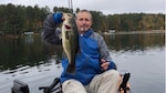 a man holding a fish on a boat