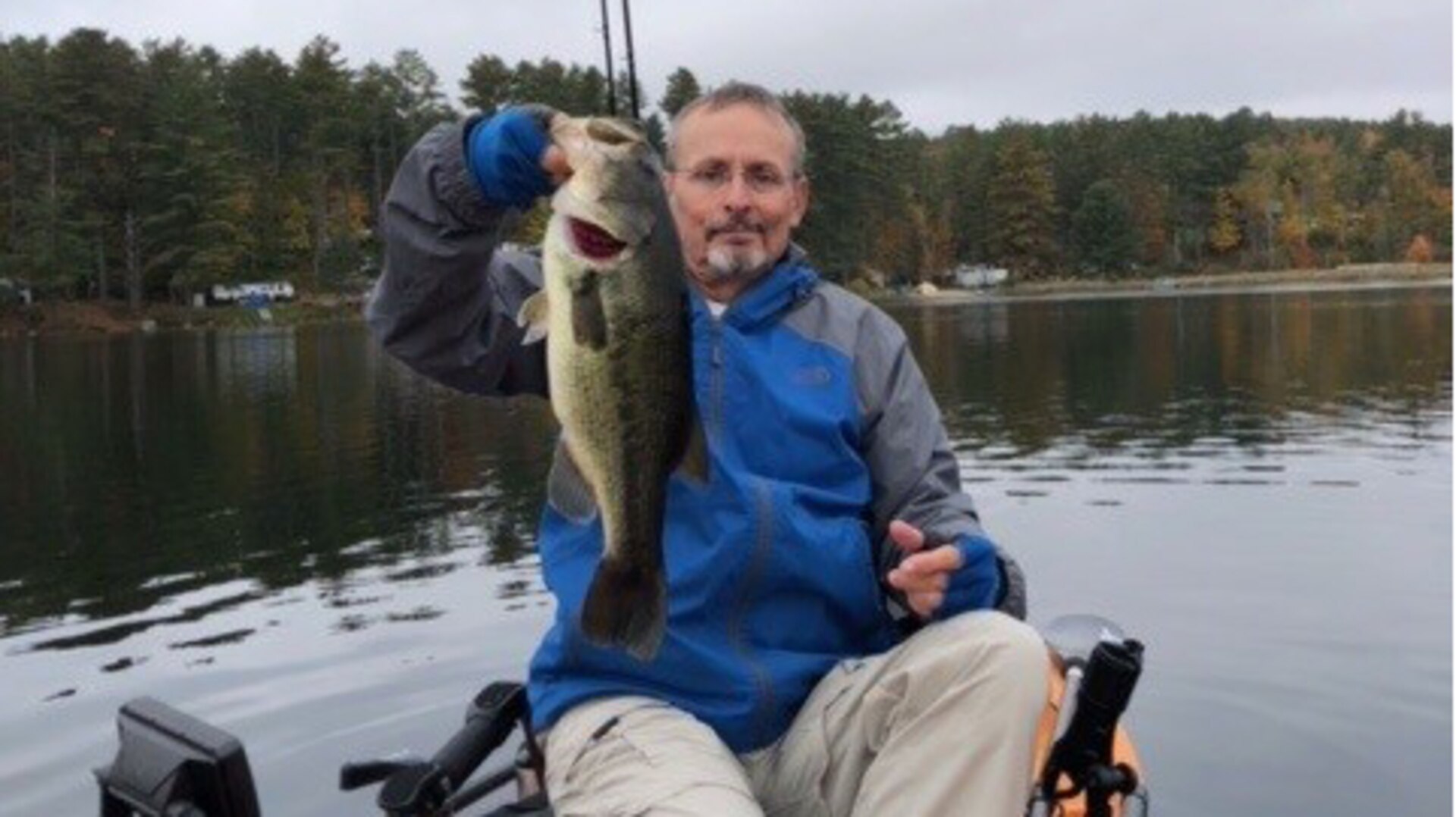 a man holding a fish on a boat