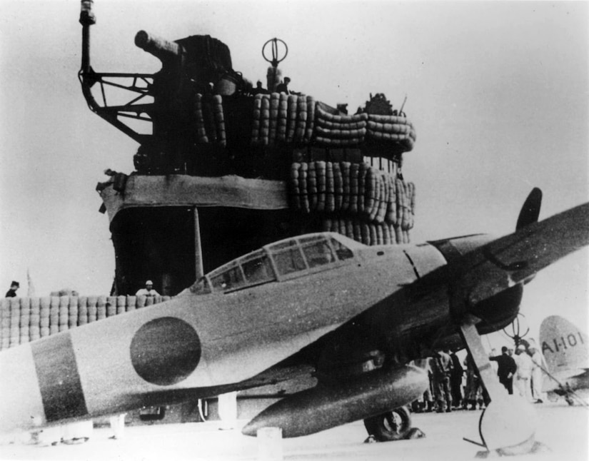 A plane is on the deck of an aircraft carrier.