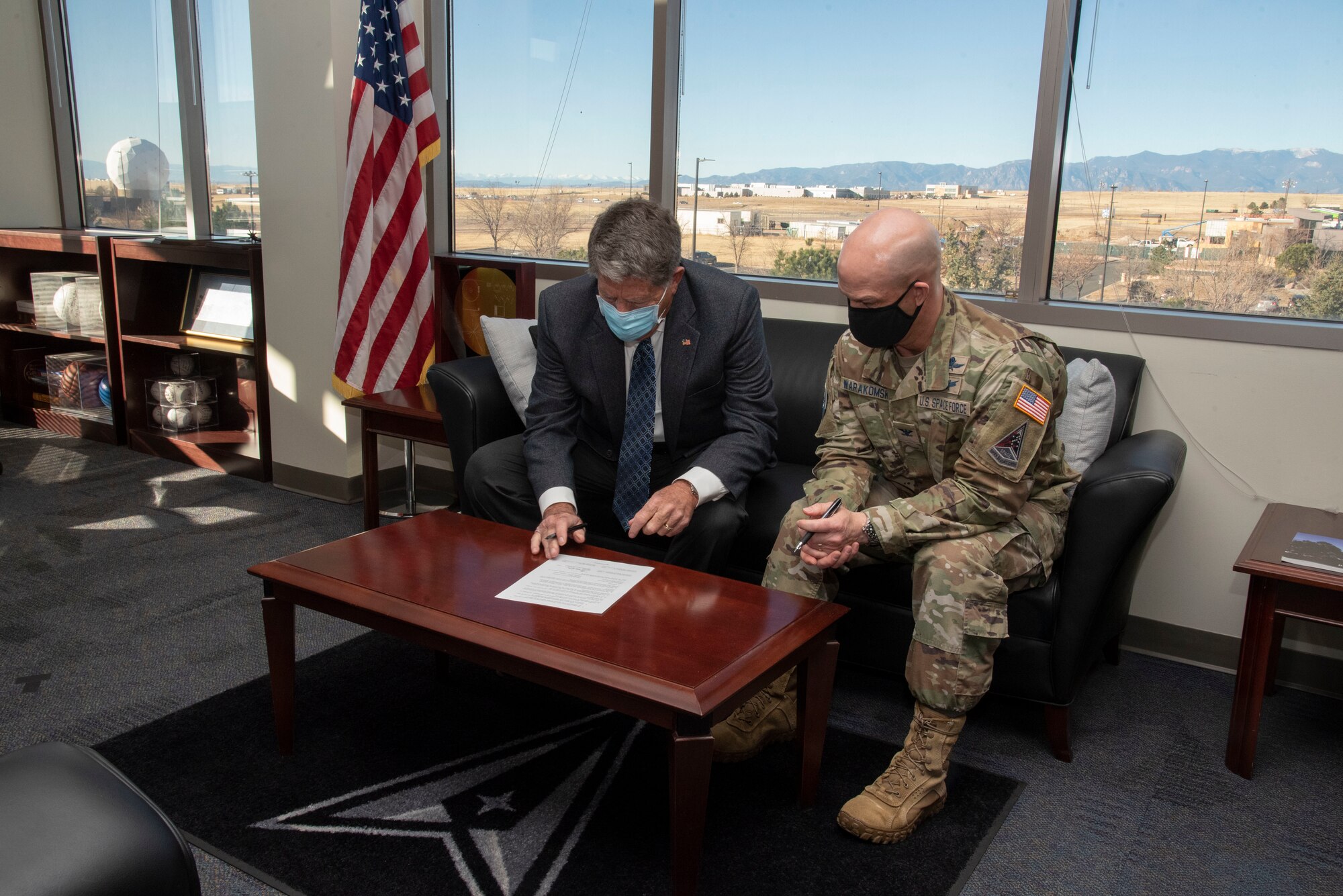 Don Addy, Pikes Peak Area Crime Stoppers chairman of the board, signs a PPACS support agreement with Peterson-Schriever Garrison instituting a new crime prevention tactic for Peterson Space Force Base and Schriever SFB, Colorado, Nov. 29, 2021.