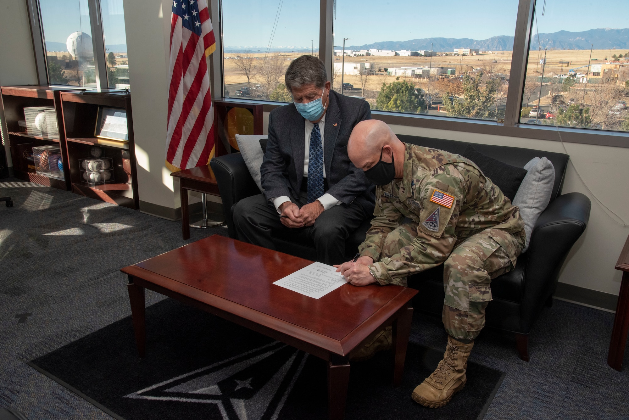 U.S. Space Force Col. Zachary Warakomski, Peterson-Schriever Garrison commander, signs a Pikes Peak Area Crime Stoppers support agreement instituting a new anonymous crime prevention tactic for residents living on Peterson Space Force Base and Schriever SFB, Colorado, Nov. 29, 2021.