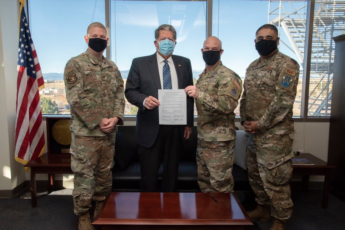 U.S. Space Force Col. Zachary Warakomski, Peterson-Schriever Garrison commander; Don Addy, Pikes Peak Area Crime Stoppers chairman of the board; U.S. Air Force Lt. Col. Jaime Hernandez, 21st Security Forces Squadron commander; and U.S Air Force Maj. Timothy Marriner, 50th Security Forces Squadron commander, pose for a photo after signing the Pikes Peak Area Crime Stoppers support agreement at Schriever Space Force Base, Colorado, Nov. 29, 2021.