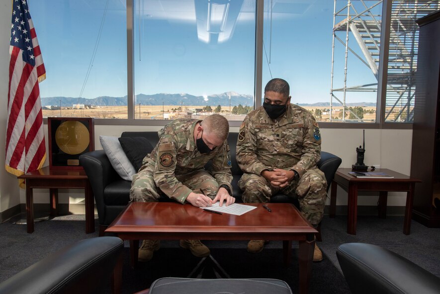 U.S Air Force Maj. Timothy Marriner, 50th Security Forces Squadron commander, signs the Peterson-Schriever Garrison and Pikes Peak Area Crime Stoppers support agreement that institutes a new crime prevention tactic for the garrison’s installations at Schriever Space Force Base, Colorado, Nov. 29, 2021.