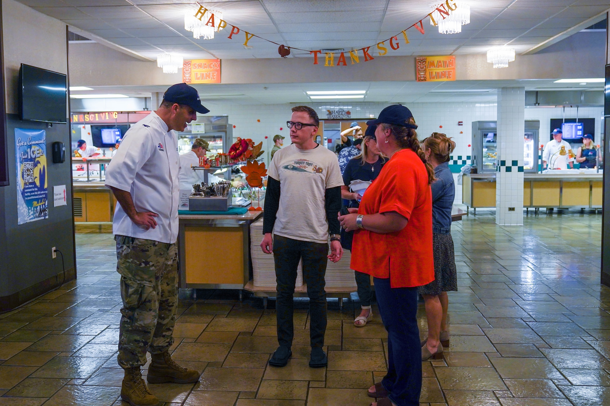 Col. Daniel Dobbels, 15th Wing commander and his wife, Lisa Dobbels greet airmen on Thanksgiving at the Hale Aina Dining Facility, November 25, 2021. Leaders from Joint Base Pearl Harbor-Hickam served airmen and their families lunch on Thanksgiving. (U.S. Air Force photo by Airman 1st Class Makensie Cooper)