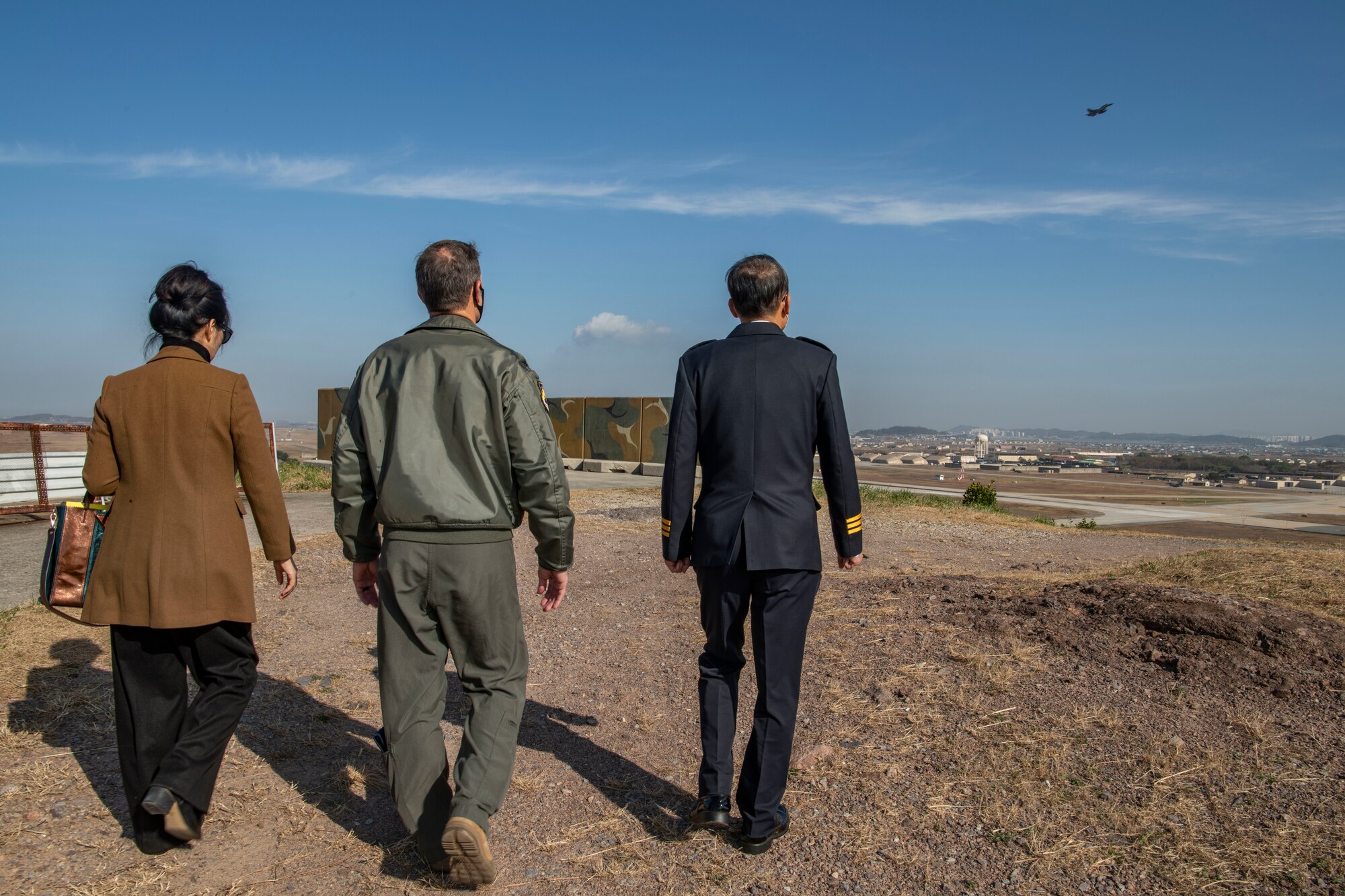 (From left) Ms. Song Ae Song (Rosemary), 8th Fighter Wing Public Affairs community relations advisor, Col. John “Wolf” Gallemore, 8th FW commander, Mr. Yi Hyong-se, Korean National Police Commissioner of Jeonbuk Province, view the base from Big Coyote during an immersion tour at Kunsan Air Base, Republic of Korea, Nov. 17, 2021. Kunsan hosts an immersion tour for the KNP biannually to provide updates on the economic impact Kunsan has on the local area. (U.S. Air Force photo by Staff Sgt. Jesenia Landaverde)
