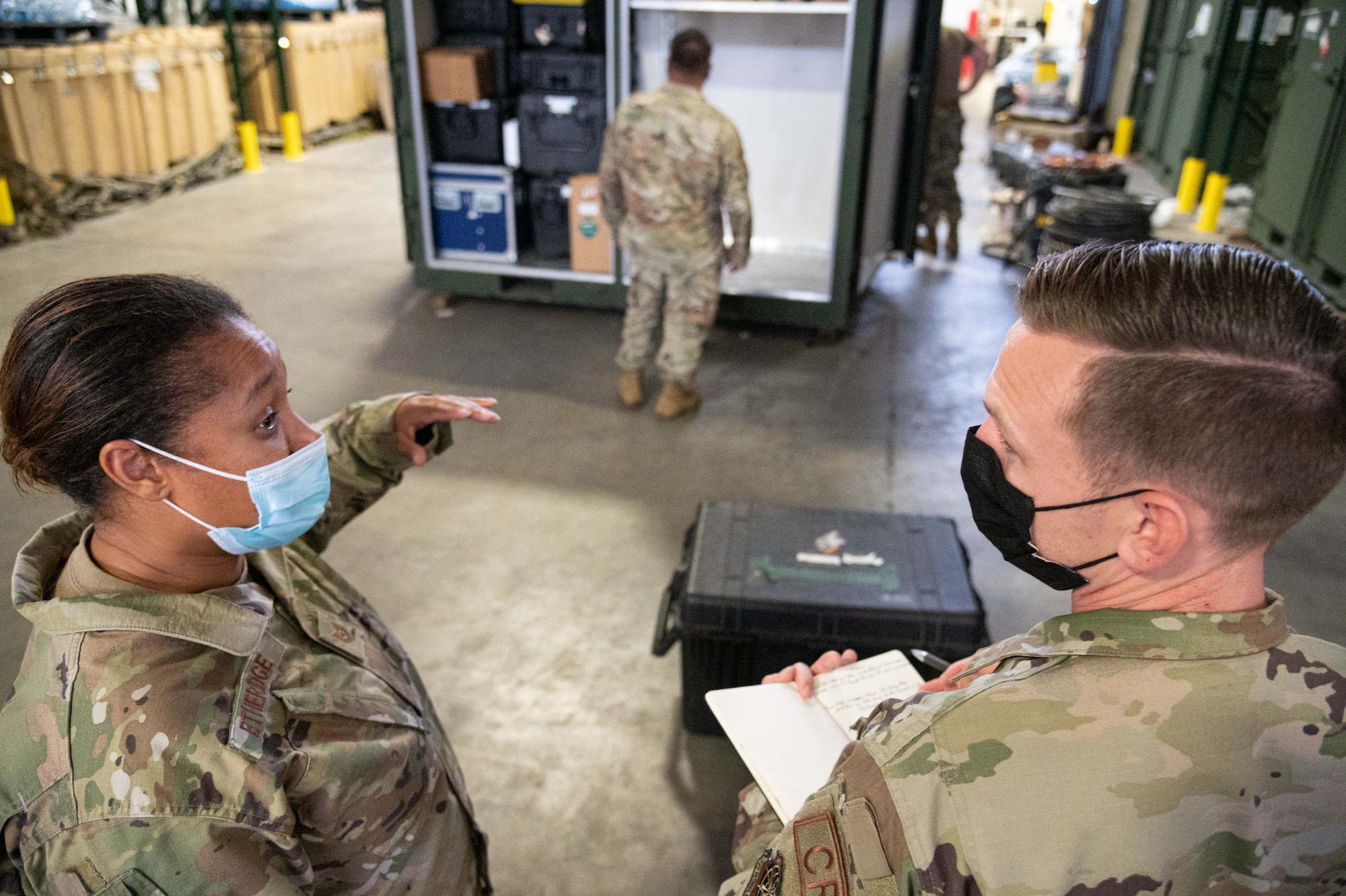 U.S. Air Force Tech. Sgt. Angela Etheridge, 821st Contingency Response Squadron aerial porter, and Tech. Sgt. Jacob Anderson, 621st Contingency Response Group unit type- code manager, discuss how to utilize space for an additional UTC Oct. 8, 2021, at Joint Base McGuire-Dix-Lakehurst, New Jersey. The 621st Contingency Response Wing is accelerating change
by adding another CR squadron to the 821st CRG at Travis Air Force Base, California, and the 621st CRG at JBMDL. (U.S. Air Force photo by Staff Sgt. Sarah Brice)