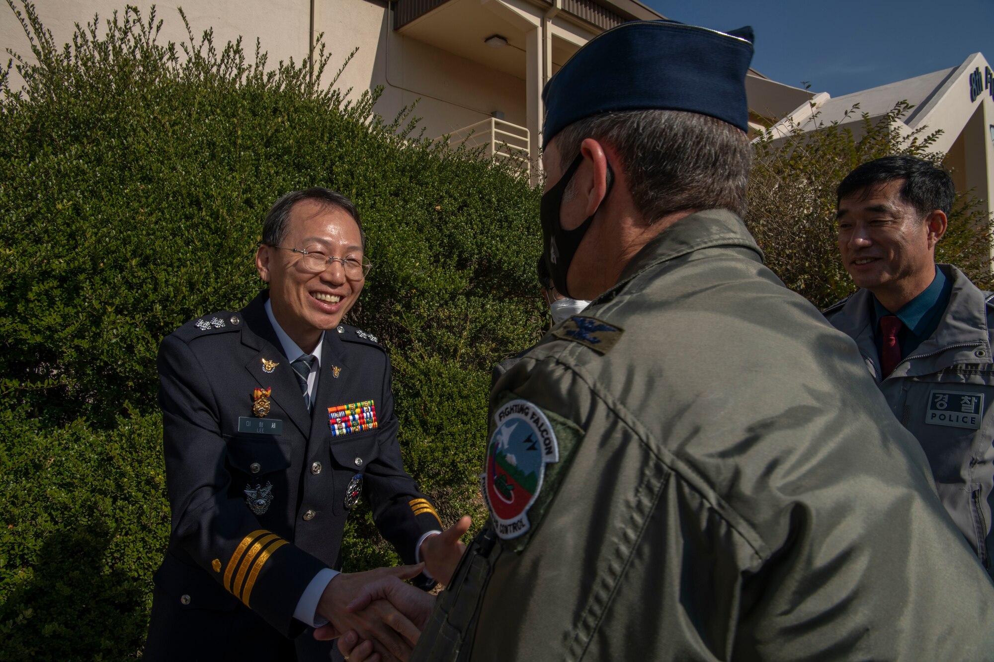 Mr. Yi Hyong-se, Korean National Police Commissioner of Jeonbuk Province shakes hands with Col. John “Wolf” Gallemore, 8th Fighter Wing commander, during an immersion tour at Kunsan Air Base, Republic of Korea, Nov. 17, 2021. Kunsan hosts an immersion tour for the KNP biannually to provide updates on the economic impact Kunsan has on the local area. (U.S. Air Force photo by Staff Sgt. Jesenia Landaverde)