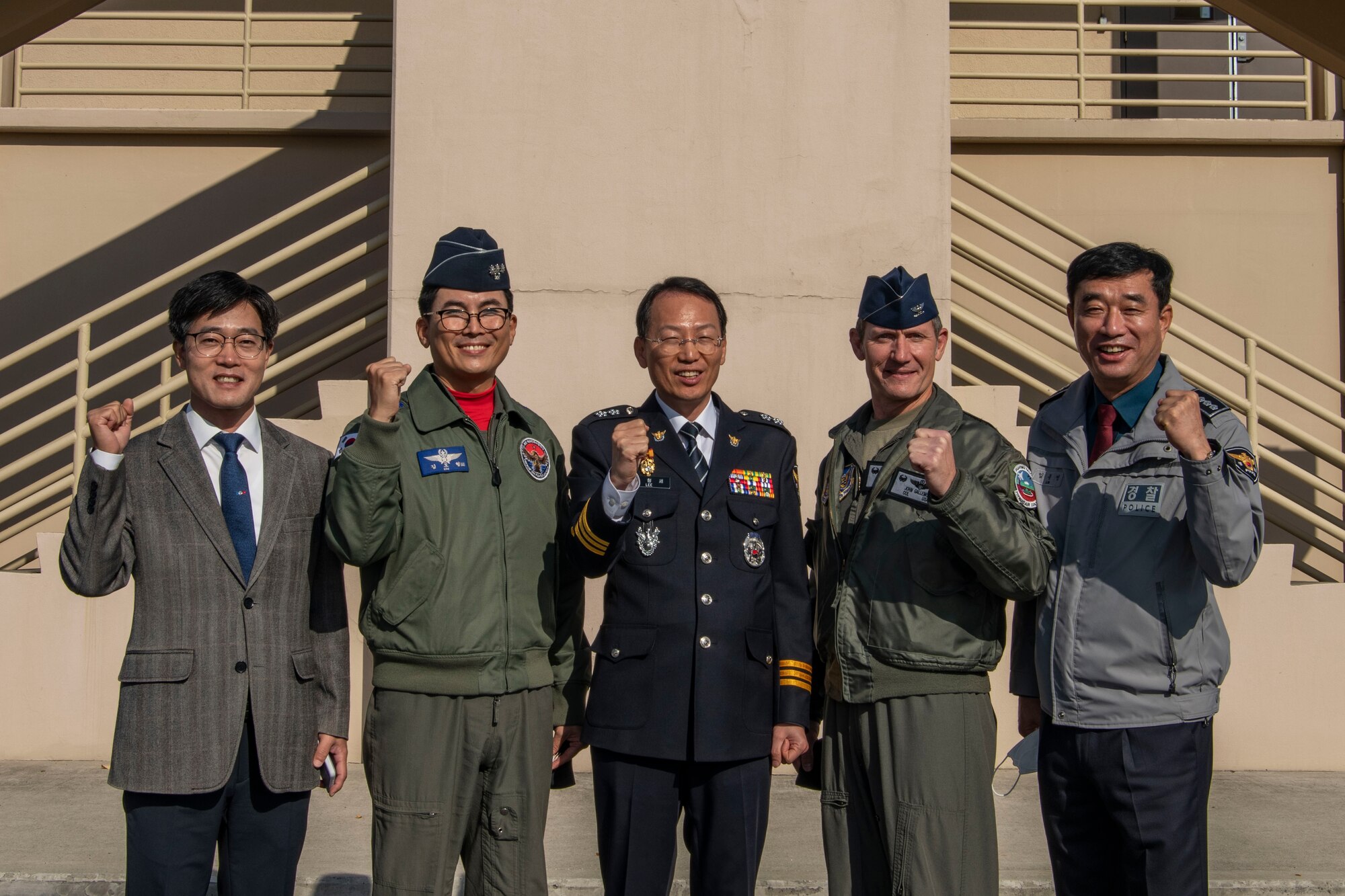 (From left) Mr. Yin Jong-myong, Korean National Police Chief of Gunsan, Col. Kim “Eagle” Do-Hyoung, 38th Fighter Group commander, Mr. Yi Hyong-se, KNP commissioner of Jeonbuk Province, Col. John “Wolf” Gallemore, 8th Fighter Wing commander, Mr. Jong Jae-bong, KNP director of Jeonbuk Province, prepare for a Kunsan Air Base immersion tour at Kunsan AB, Republic of Korea, Nov. 17, 2021. Kunsan hosts an immersion tour for the KNP biannually to provide updates on the economic impact Kunsan has on the local area. (U.S. Air Force photo by Staff Sgt. Jesenia Landaverde)