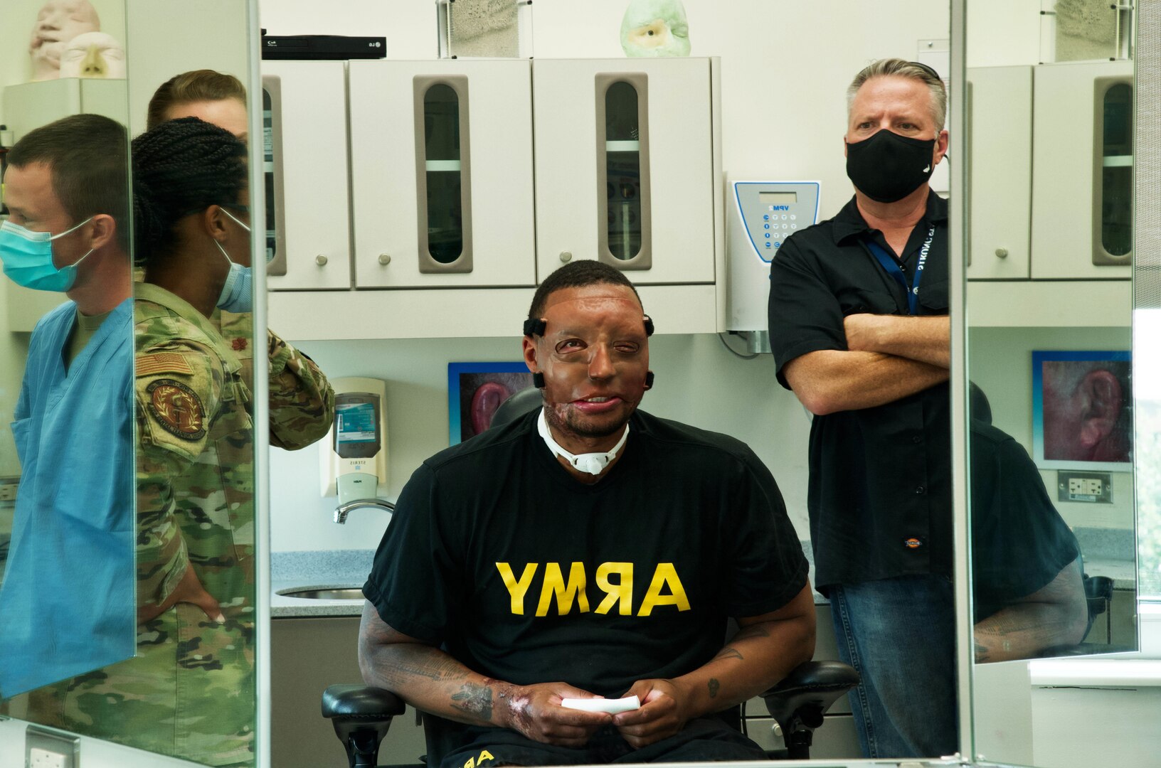 Patient observes reflection of face prosthetic