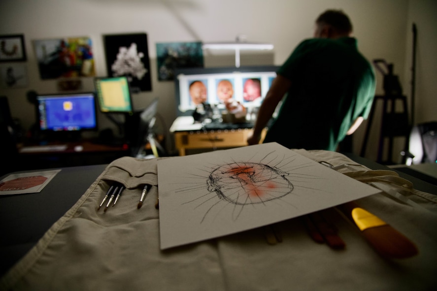 Medical illustrator airbrushes face prosthetic