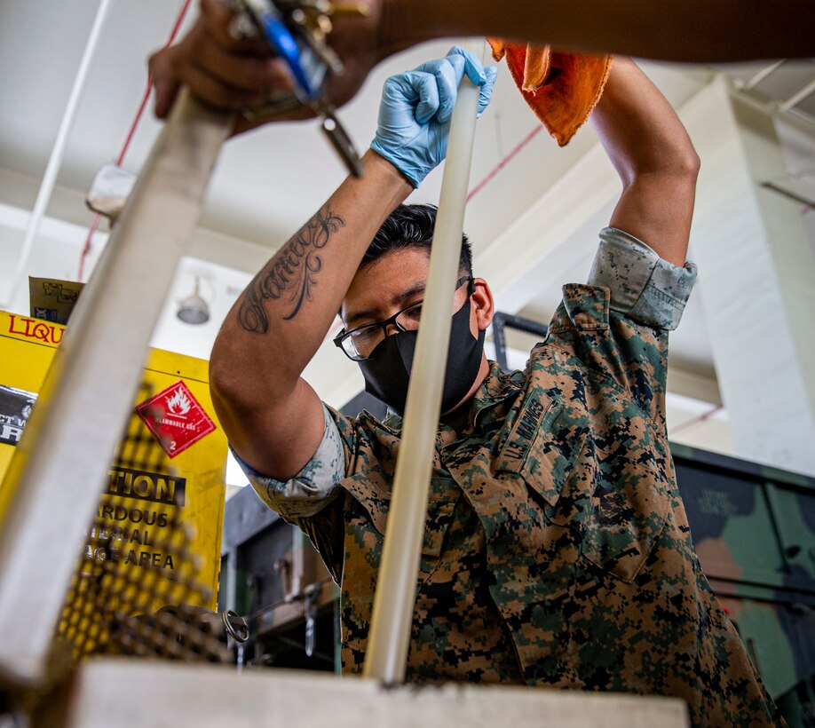 U.S. Marine Corps Cpl. Rendy Catete, the training noncommissioned officer in charge with the Environmental Support Team, Headquarters and Support Battalion, Marine Corps Installations Pacific, conducts a fluid check for an oil container on Camp Foster, Okinawa, Japan, Sep. 28, 2021. Catete was originally born in the U.S. and moved to Monterrey, Mexico, with his family where he lived for the first three years of his life. His parents, seeking better paying jobs and higher education for their four children, immigrated to Dallas, Texas, and began their family’s journey to citizenship. (U.S. Marine Corps photo by Lance Cpl. Alex Fairchild)