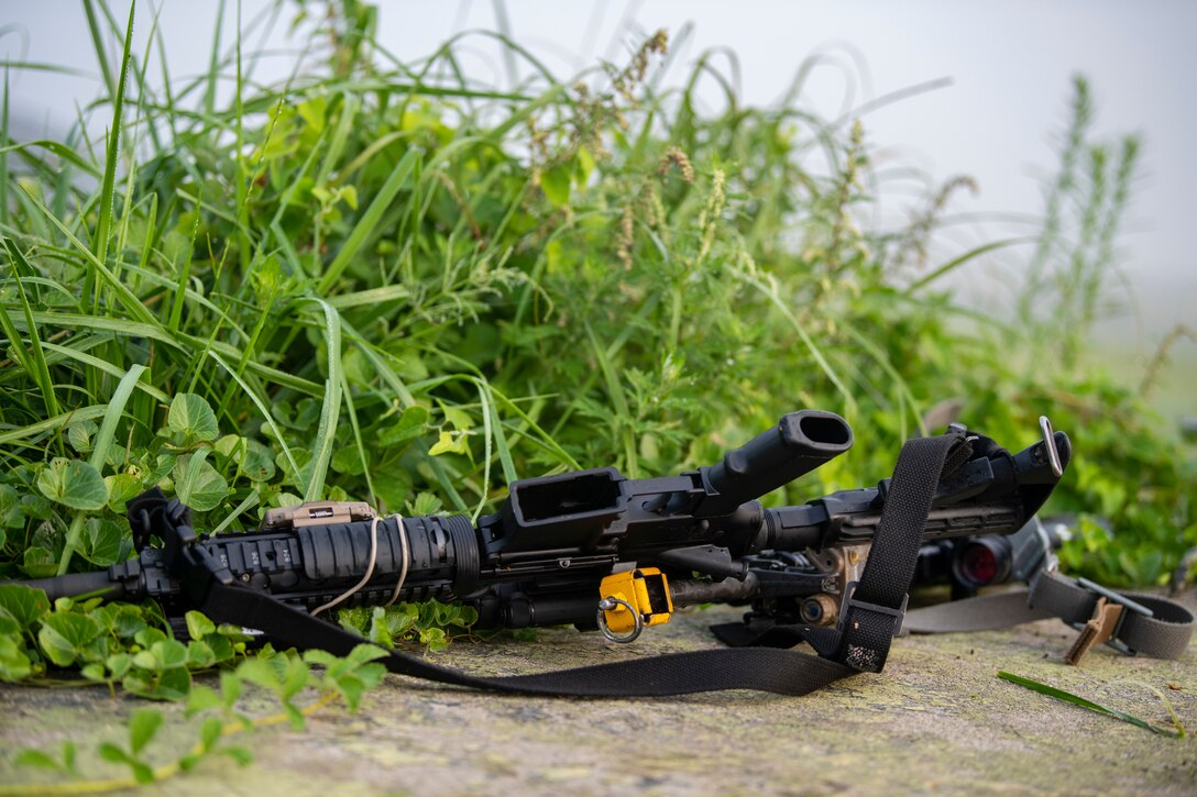 An M4 Carbine lays on the ground after 8th Security Forces Squadron Airmen defend the base from opposing forces during a routine training event at Kunsan Air Base, Republic of Korea, Oct. 1, 2021. Security forces undergo constant training to ensure they are always ready to fight tonight. (U.S. Air Force photo by Senior Airman Suzie Plotnikov)