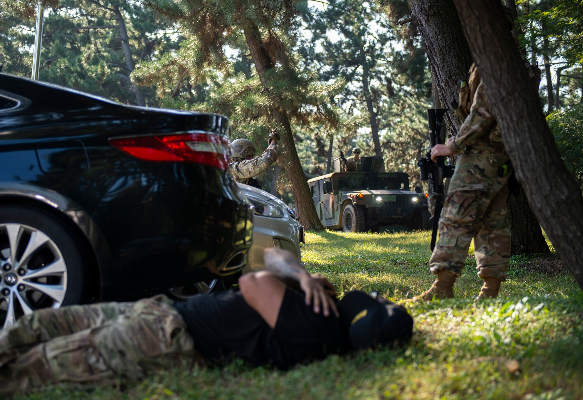 Defenders from the 8th Security Forces Squadron communicate with each other during a routine training event at Kunsan Air Base, Republic of Korea, Sept. 30, 2021. Defenders posing as opposing forces broke into the 8th Medical Group to test and enhance the lethality and readiness of the 8th SFS. (U.S. Air Force photo by Senior Airman Suzie Plotnikov)