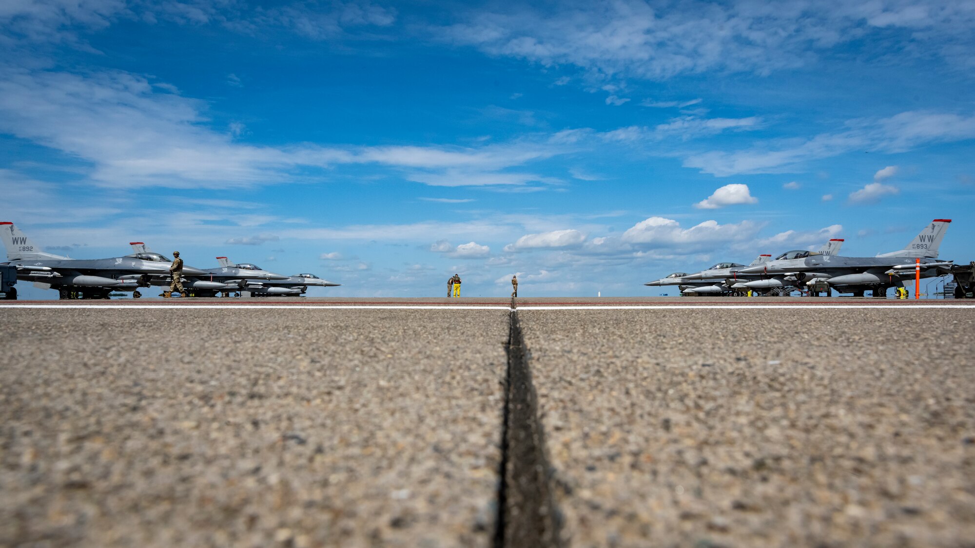 Fighter jets positioned on the flight line prior to taking off.