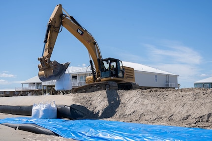 Louisiana National Guardsmen assigned to the 225th Engineer Brigade emplace 3-by-3 foot sacks filled with up to 4,000 pounds of sand each along 12 levee breaches, Grand Isle, La., Sept 24, 2021. Tidal surge from Hurricane Ida damaged the island’s levee leading to massive flooding.