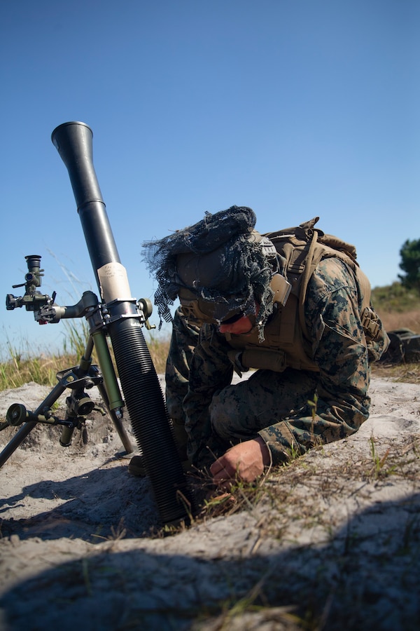 U.S. Marine Corps Pfc. Jason Ditzel, a Wood-Ridge, N.J., native with 1st Battalion, 2d Marine Regiment (1/2), 2d Marine Division, adjusts the position of an M252 81mm mortar system during Exercise Burmese Chase on Camp Lejeune, N.C., Sept. 28, 2021.