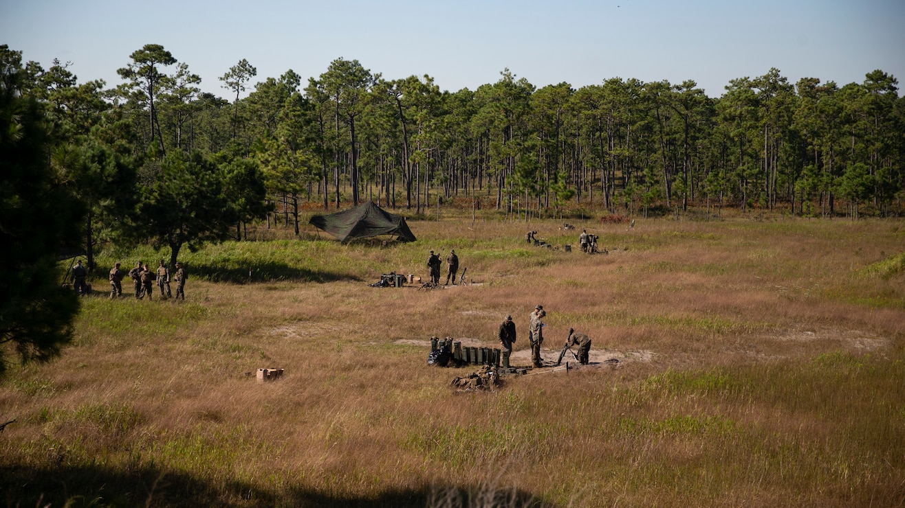 U.S. Marines with 1st Battalion, 2d Marine Regiment (1/2), 2d Marine Division, standby in between fire missions during Exercise Burmese Chase on Camp Lejeune, N.C., Sept. 28, 2021. Burmese Chase is an annual U.S.-led multi-lateral exercise that includes training on integration of ground and air fires, infantry tactics, and naval gunfire alongside NATO allies and partners. (U.S. Marine Corps photo by Lance Cpl. Deja Thomas)