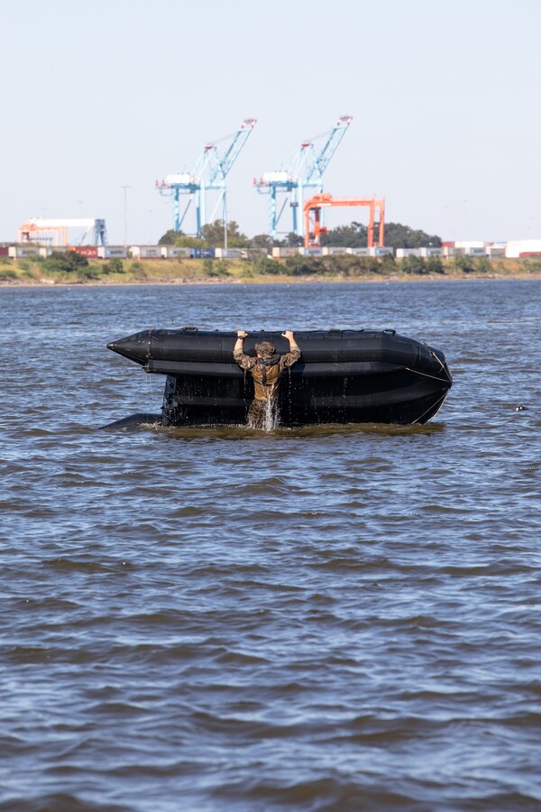 U.S. Marines with 3d Force Reconnaissance Company, 4th Marine Division, Marine Forces Reserve, flip a combat rubber raiding craft during small boat familiarization training in Mobile, Alabama, Sept. 25, 2021. Marines with 3d Force Reconnaissance Co. operate small surface craft to conduct amphibious operations such as amphibious reconnaissance and limited-scale raids. (U.S. Marine Corps photo by Cpl. Brendan Mullin)