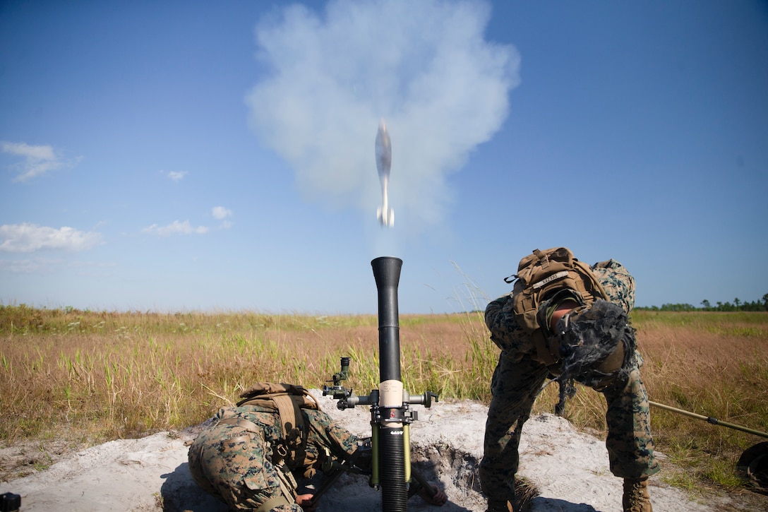 U.S. Marine Corps Pfc. Kenneth Slizewski, left, a Staten Island, N.Y., native, and Pfc. Jason Ditzel, a Wood-Ridge, N.J., native with 1st Battalion, 2d Marine Regiment (1/2), 2d Marine Division, fire an 81mm mortar round during Exercise Burmese Chase on Camp Lejeune, N.C., Sept. 28, 2021. Burmese Chase is an annual U.S.-led multi-lateral exercise that includes training on integration of ground and air fires, infantry tactics, and naval gunfire alongside NATO allies and partners. (U.S. Marine Corps photo by Lance Cpl. Deja Thomas)