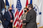 Eddy Poprock, left; Rear Admiral Kristen Fabry, center; Dan Bell, right.