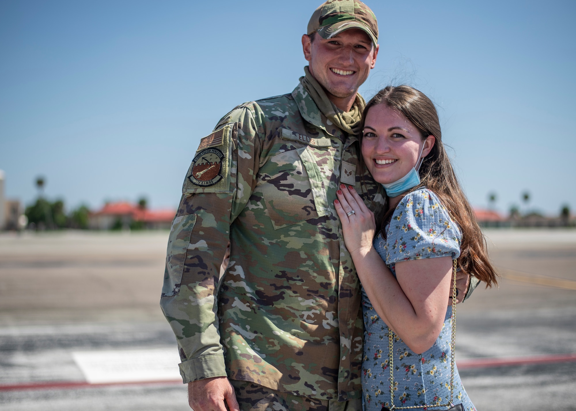 U.S. Air Force Senior Airman Jakob Ellis, a 6th Maintenance Group maintenance specialist, poses for a photo with a loved one after returning from deployment at MacDill Air Force Base, Florida, Sept. 27, 2021.