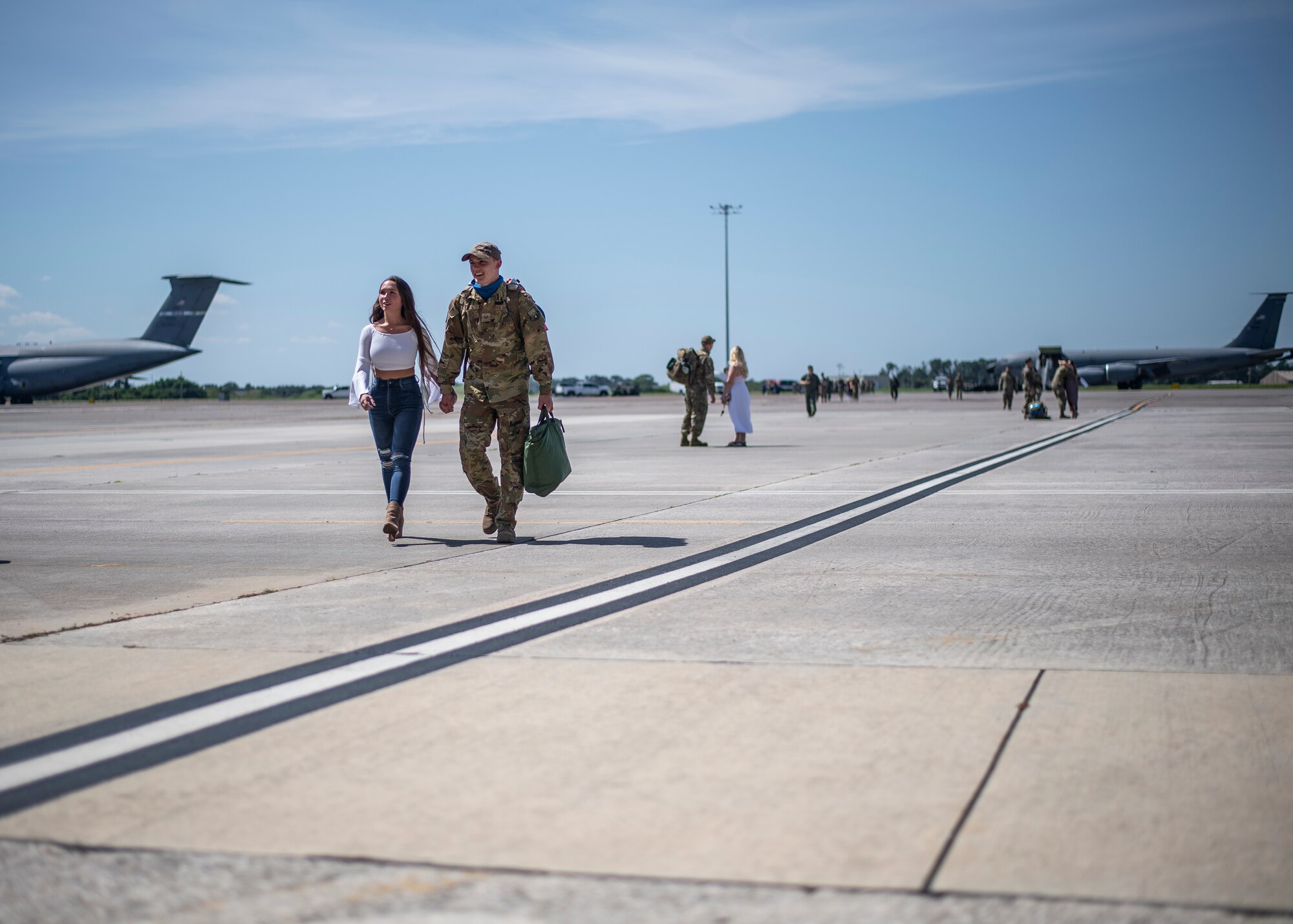 Airmen from the 6th Maintenance Group walk with their families after returning home from deployment at MacDill Air Force Base, Florida, Sept. 27, 2021.