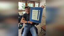 Ellis displays his award.