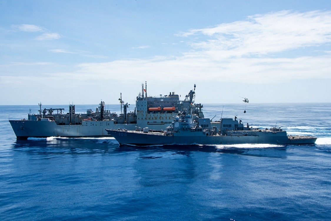 Guided-missile destroyer USS Stockdale (DDG 106), front, and guided missile cruiser USS Shiloh (CG 67) conduct a replenishment-at-sea with Military Sealift Command dry cargo and ammunition ship USNS Washington Chambers (T-AKE 11) while an MH-60S Sea Hawk, attached to the Golden Falcons of Helicopter Sea Combat Squadron (HSC) 12, conducts a vertical replenishment between Washington Chambers and the U.S. Navy’s only forward-deployed aircraft carrier, USS Ronald Reagan (CVN 76).