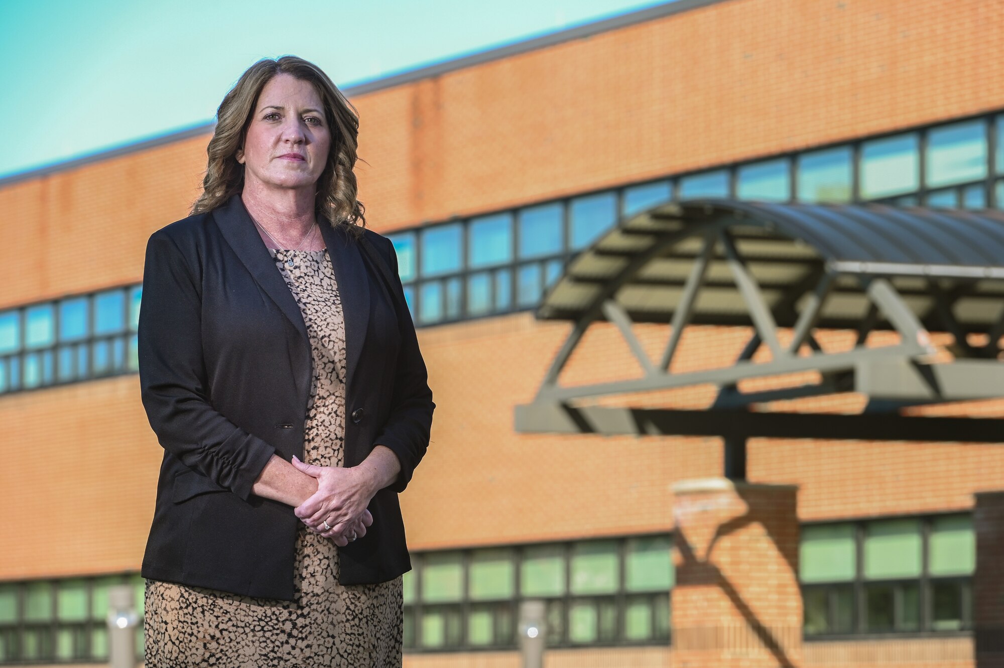 Dorothy Febbi, Operational Contracting Division chief, stands outside her work center at Hanscom Air Force Base, Mass., Sept. 28. Febbi will retire in October following a 35-year career of civil service. (U.S. Air Force photo by Todd Maki)
