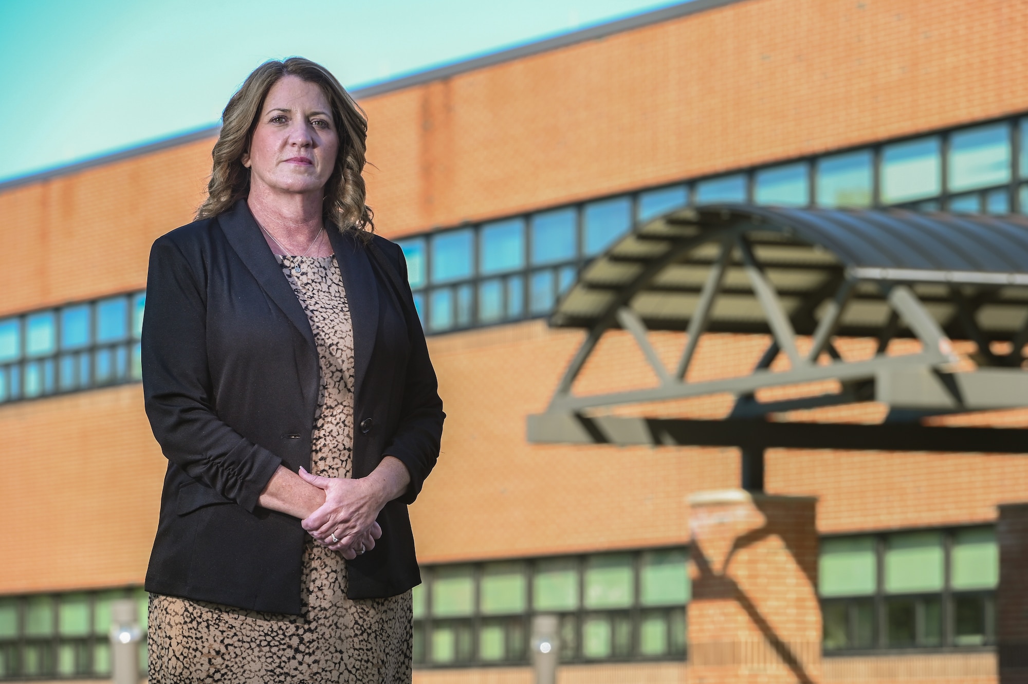Dorothy Febbi, Operational Contracting Division chief, stands outside her work center at Hanscom Air Force Base, Mass., Sept. 28. Febbi will retire in October following a 35-year career of civil service. (U.S. Air Force photo by Todd Maki)